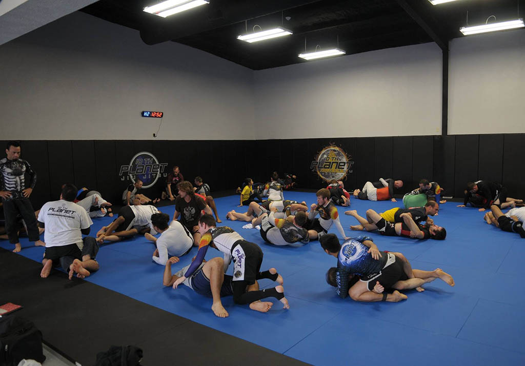 Two students practicing no-gi Brazilian Jiu-Jitsu at 10th Planet Beaumont, Texas