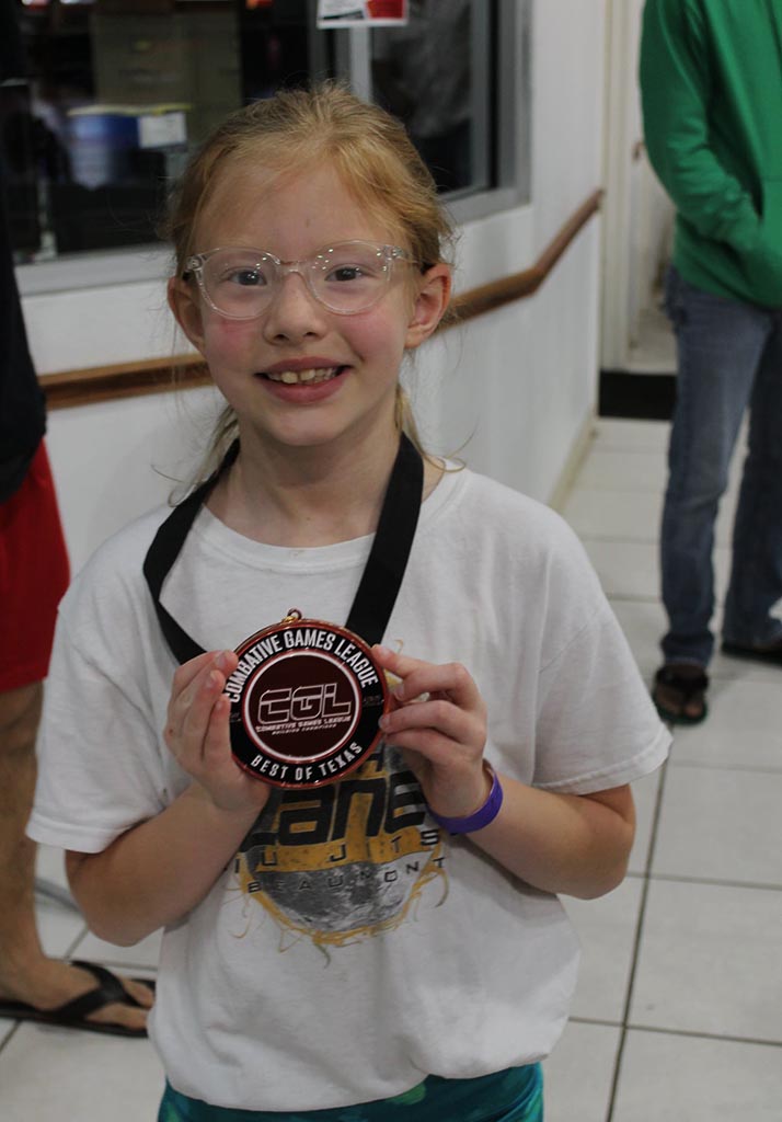 Youth students earning medals at a martial arts competition