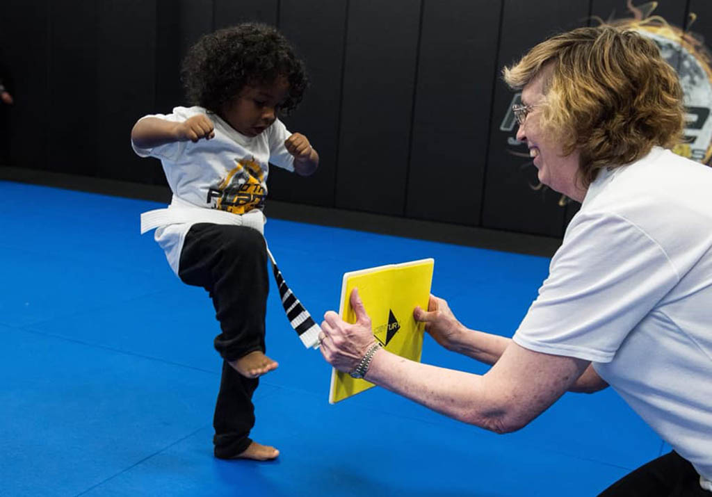 Little Dragons student breaking a board at 10th Planet Beaumont
