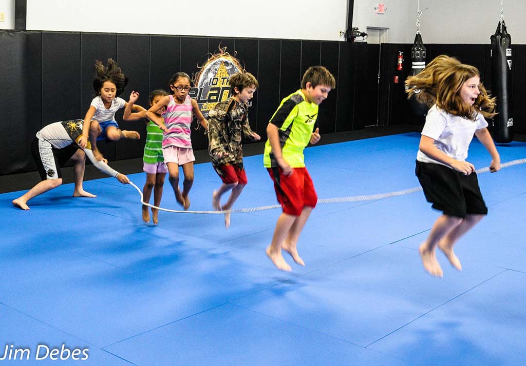 Young students warming up with jump ropes at 10th Planet Beaumont