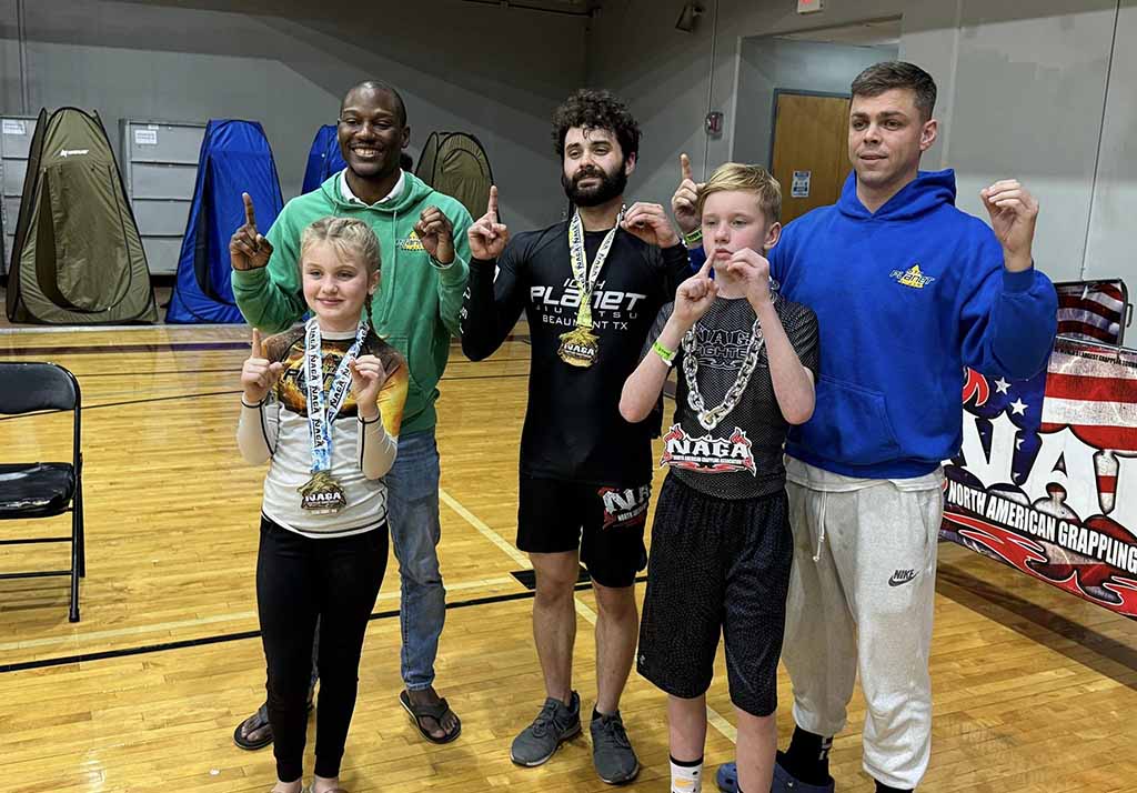 Youth student with medal after competing for 10th Planet Beaumont