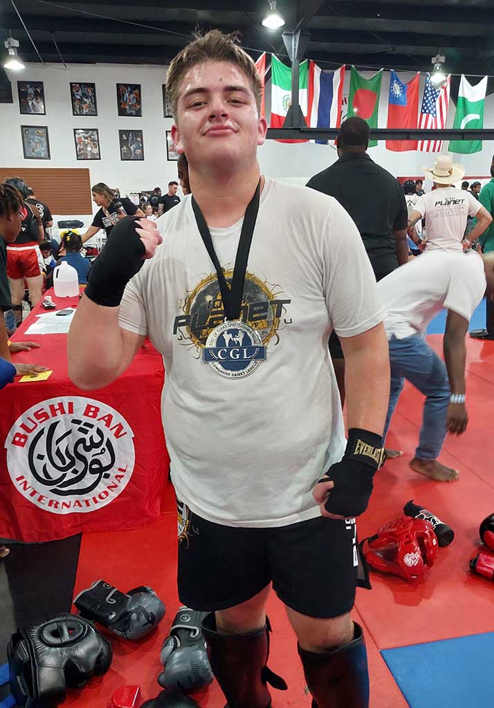 Young 10th Planet Beaumont students with medals at a grappling competition