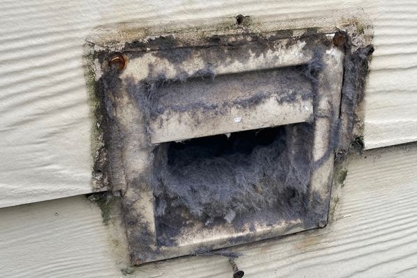 Professional dryer vent cleaning service in action